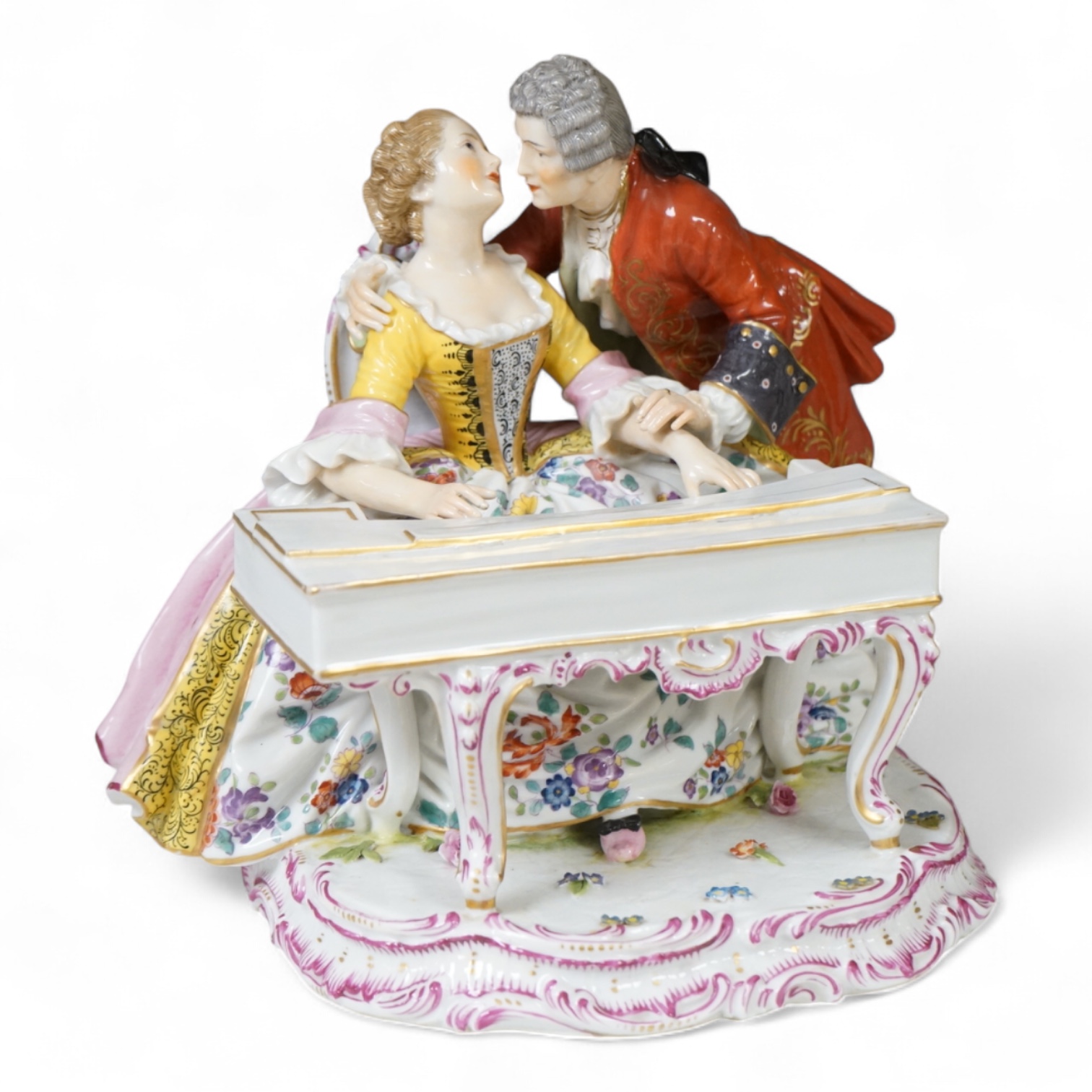 A large German porcelain group lovers at a piano, 22cm high